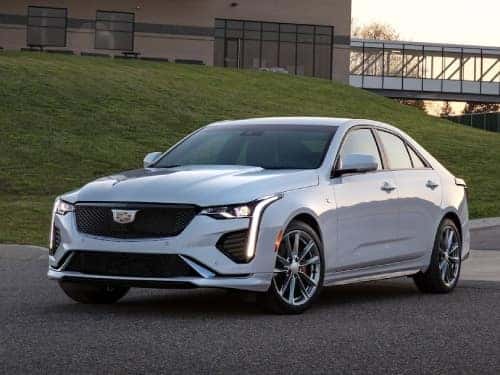 2024 Cadillac CT4 exterior view of vehicle parked outside a building with headlights on