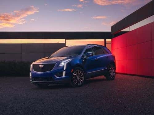 2024 Cadillac XT5 parked out side a building at night with headlights on