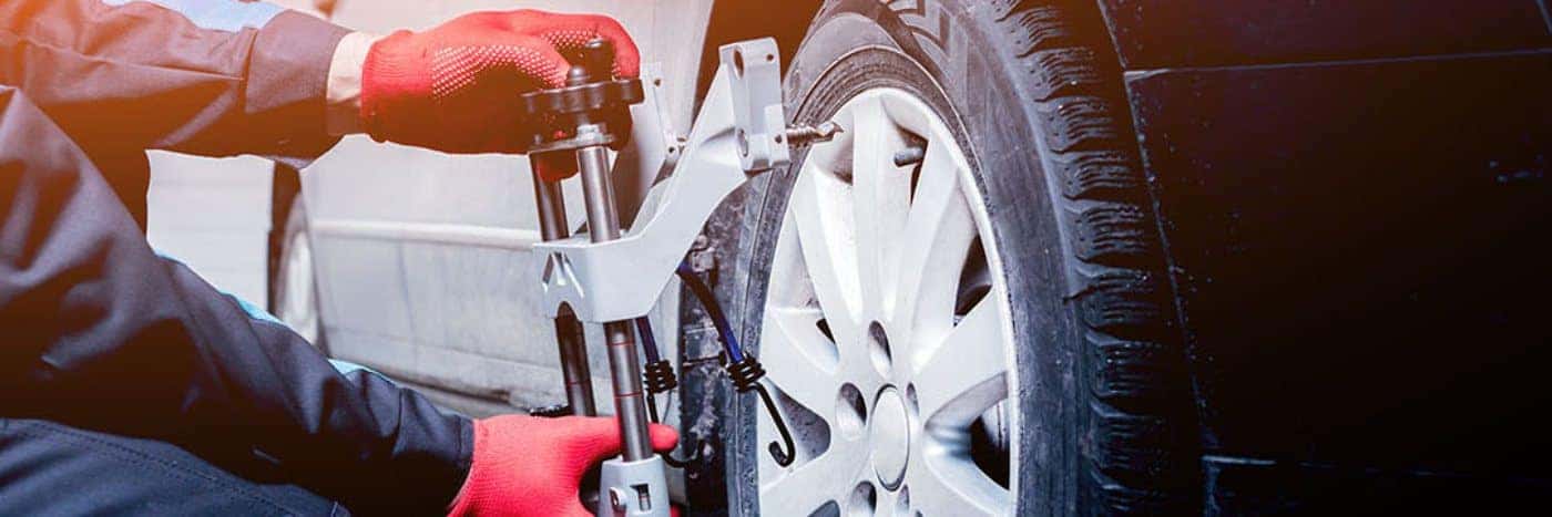 Close up view of a service tech aligning a wheel