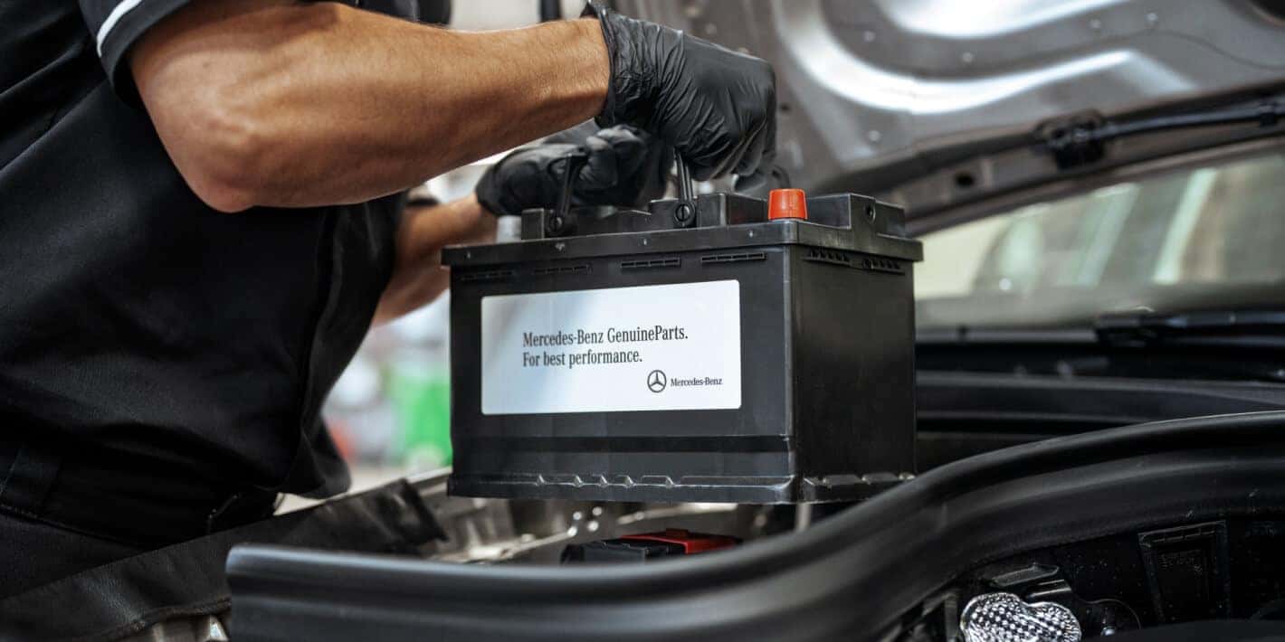 A Mercedes Benz Technician installs a new Mercedes Genuine Parts battery.