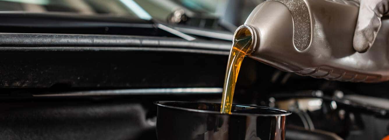 Engine bay receives fresh motor oil in a professional service garage