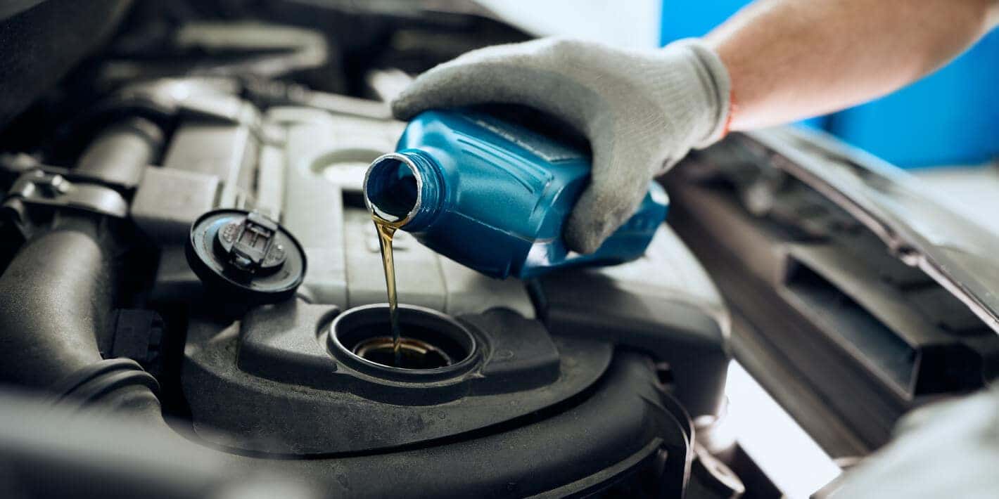 Engine bay receives a fresh motor oil change inside an auto service center