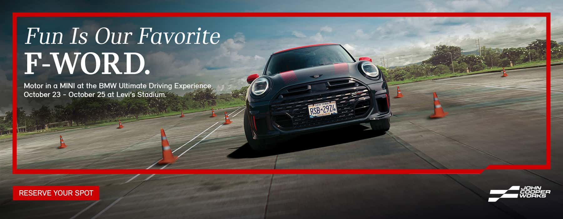 Black and red JCW on a track driving through cones.