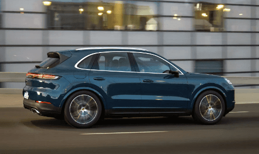 2024 Porsche Cayenne running on street side view