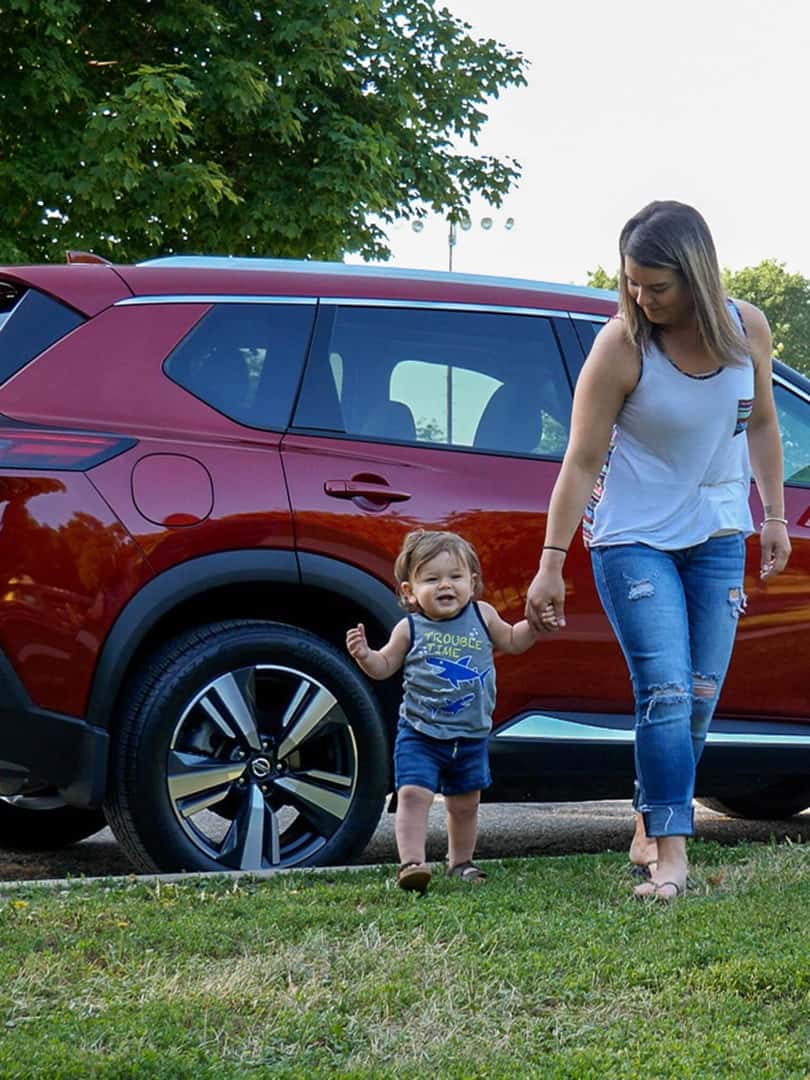 mother and son walking from Nissan Rogue