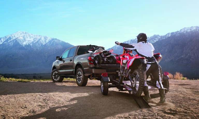 Person loading dirtbike into 2022 Nissan TITAN
