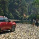 red nissan armada at a cabin by the lake