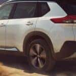 white nissan rogue going offroad