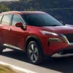 Red 2023 Nissan Rogue on Highway