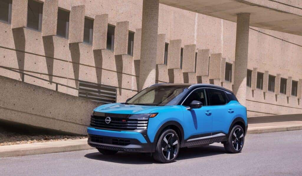 An Electric Blue 2025 Nissan Kicks Driving On The Highway