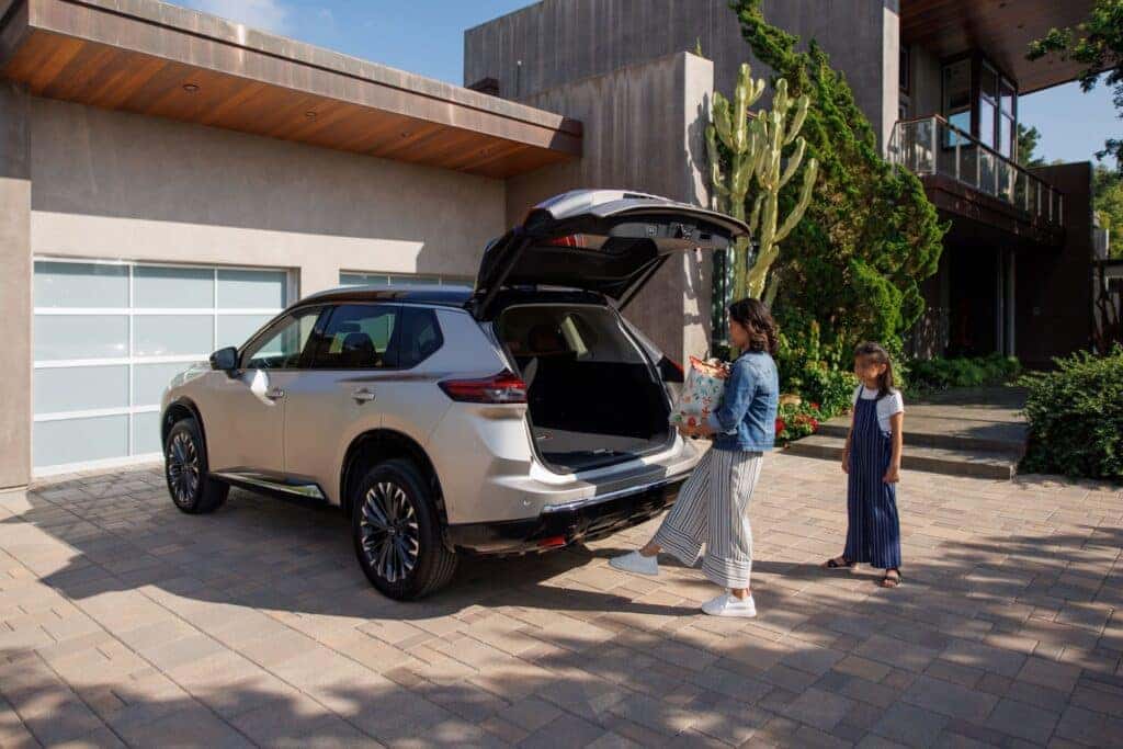 A Daughter Watching Her Mother Place A Present In The Cargo Space