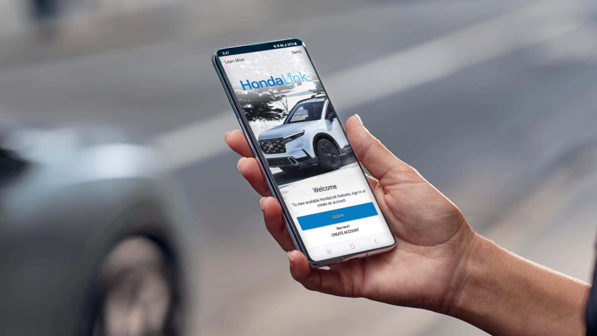 honda link app on a phone with a person holding the phone