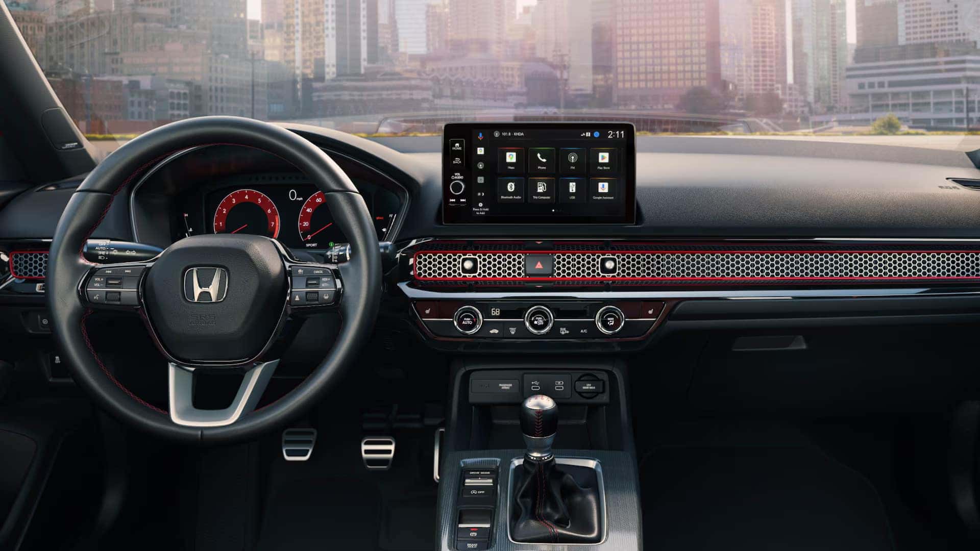 the technology display in a 2025 honda civic sedan with the view of a city scape