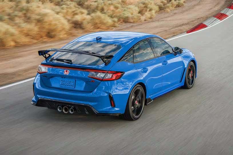 A blue car driving on the road.