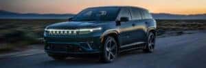 2025 jeep wagoneer driving on road with sunset