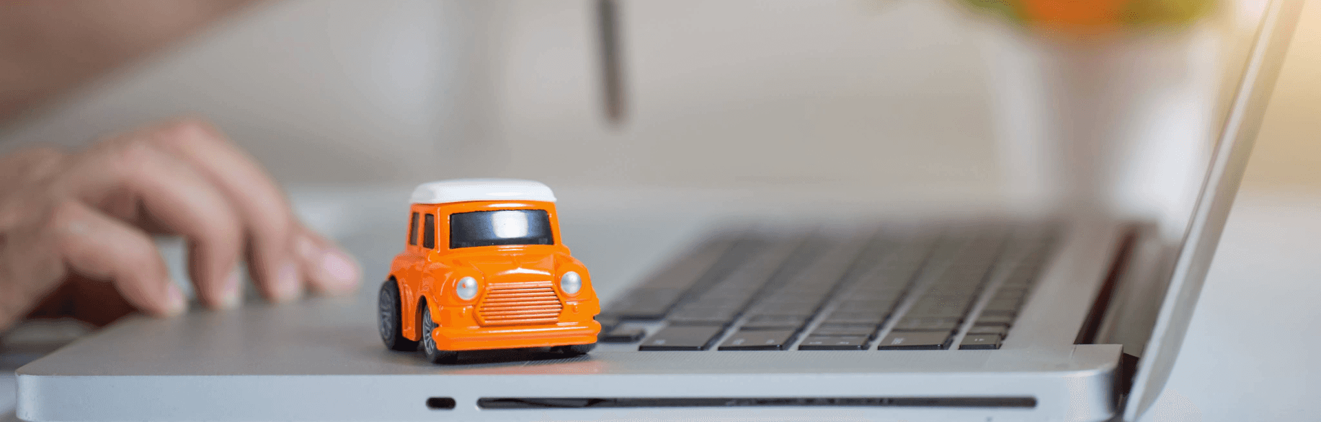 Car toy over laptop
