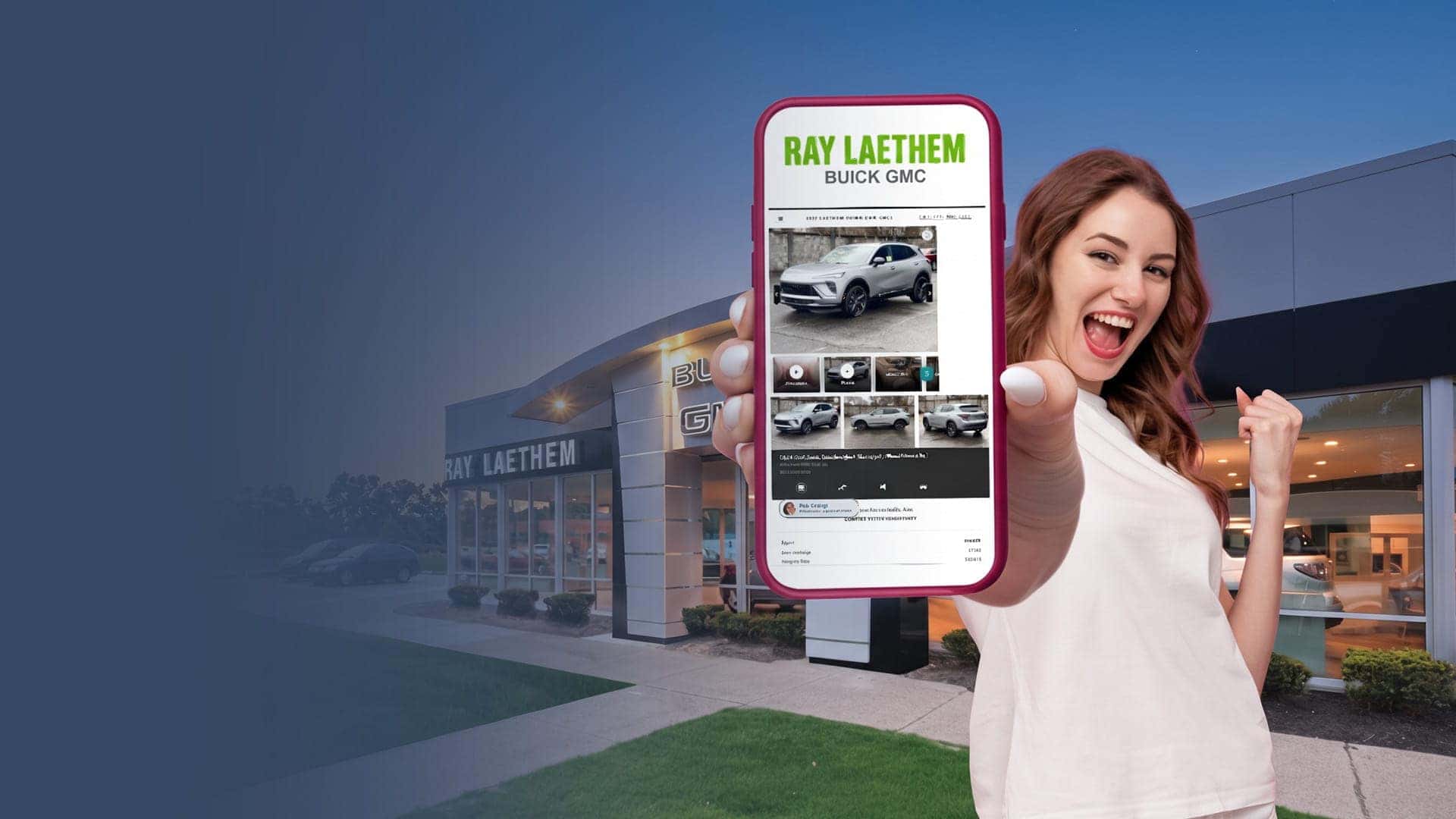 Smiling shopper holding a phone showing Ray Laethem Buick GMC inventory in front of the dealership