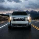 Front view of white 2027 Kia Telluride driving