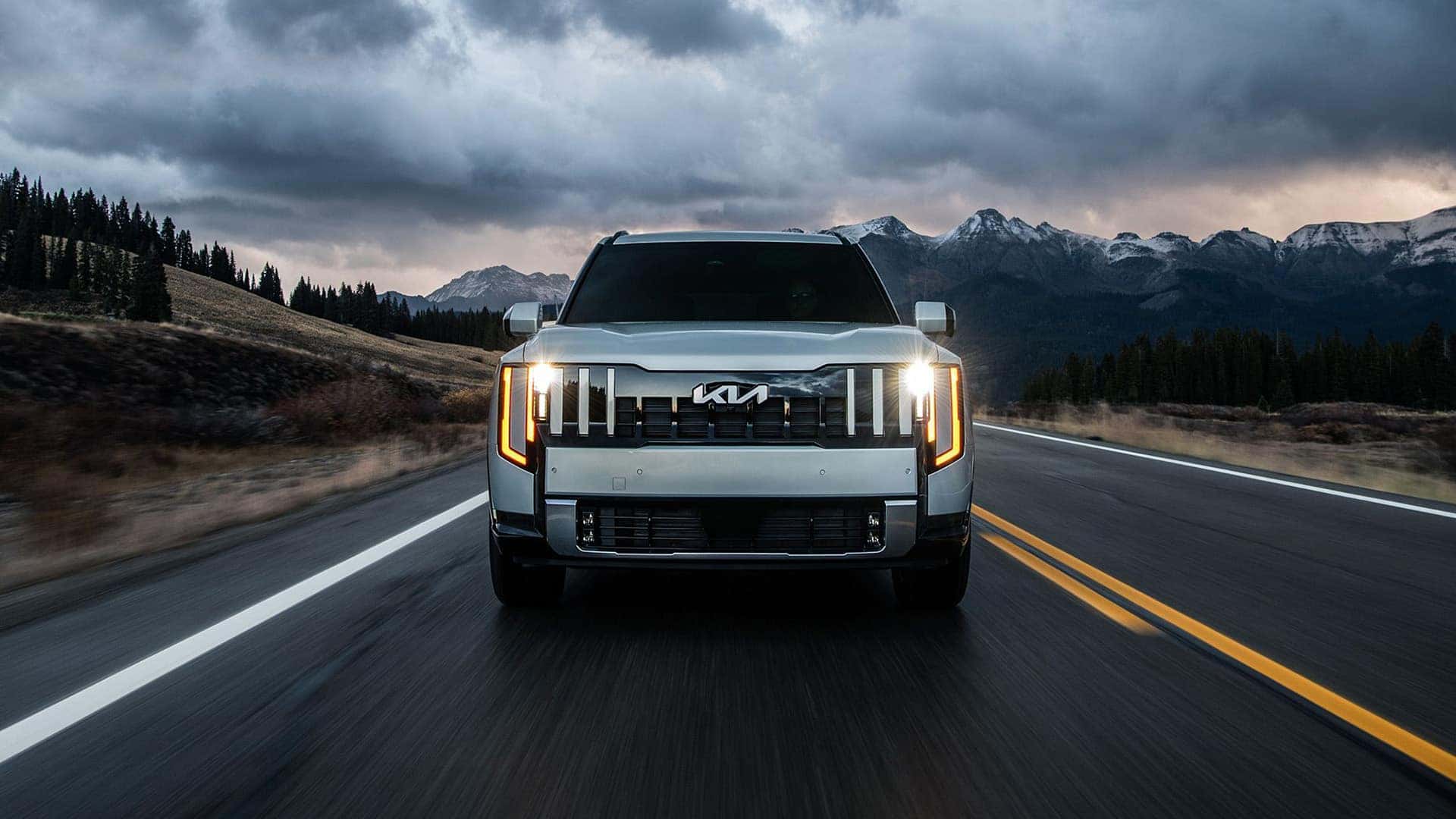 Front view of white 2027 Kia Telluride driving