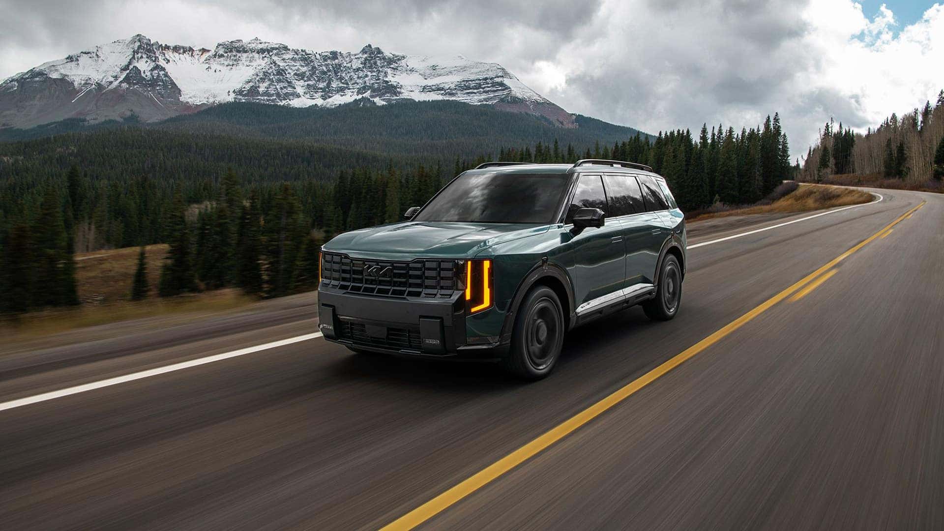 Green 2027 Kia Telluride driving down the road