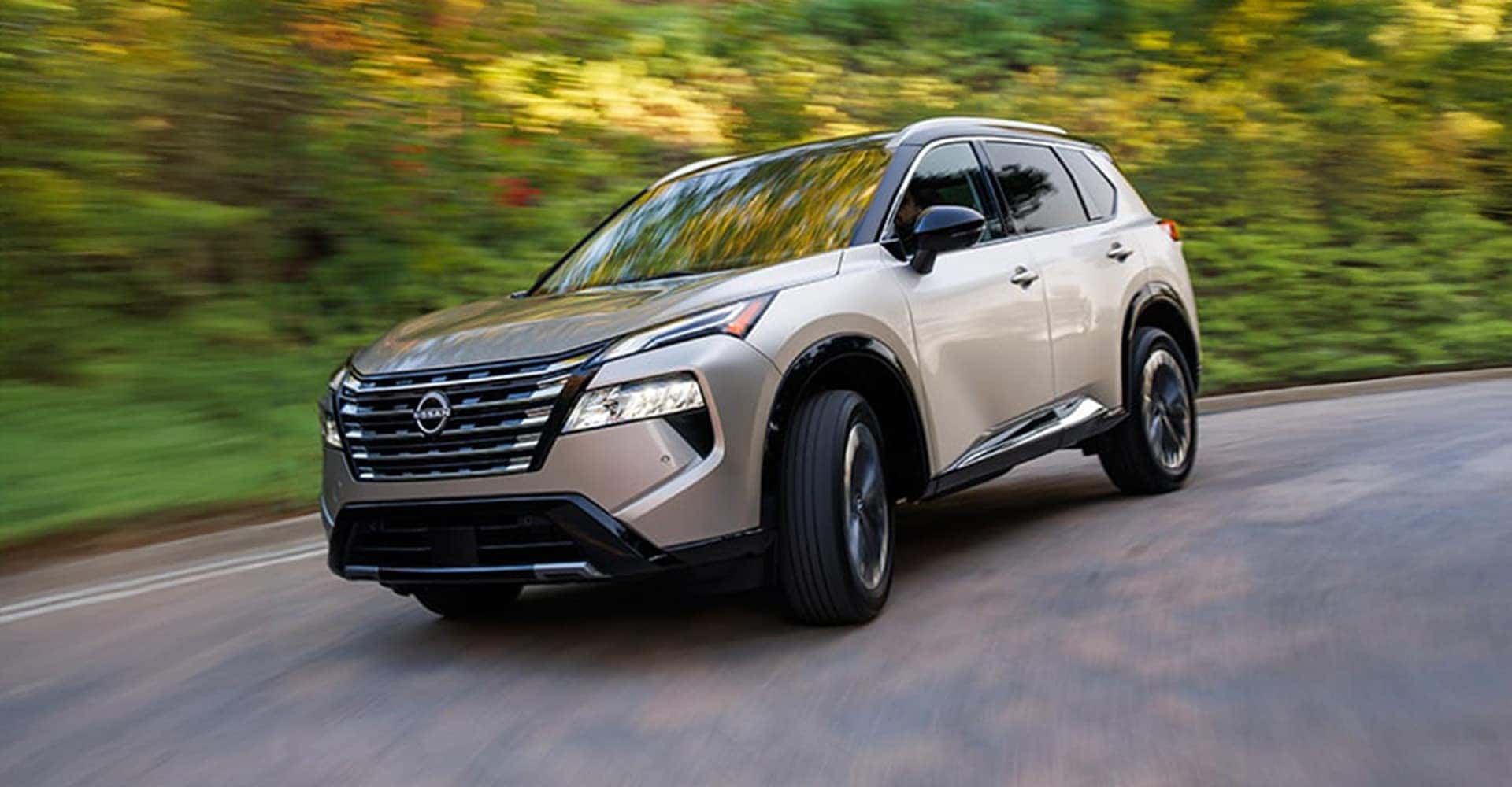 2025 Nissan Rogue driving down winding road