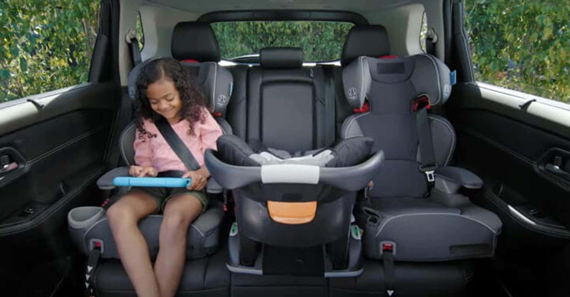 Child strapped in back seat of 2025 Nissan Rogue