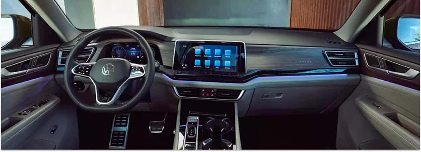 Dashboard and front interior cockpit of a 2026 Volkswagen Atlas featuring a central touchscreen and digital cluster.