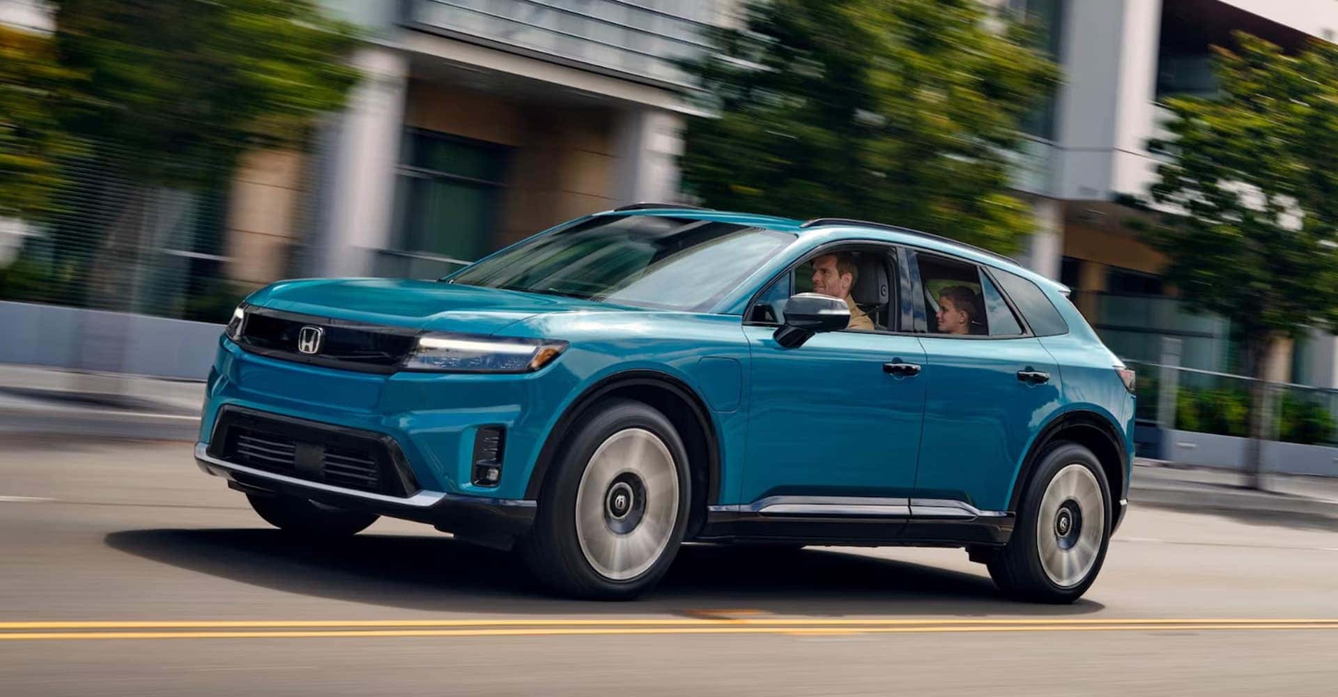 Blue 2025 Honda Prologue driving fast