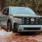 2026 Honda Pilot in light green driving in creek