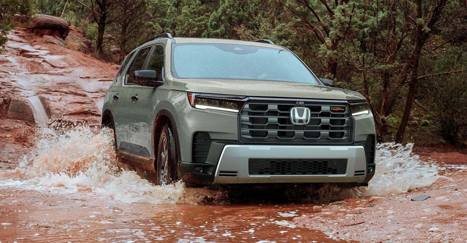 2026 Honda Pilot in light green driving in creek