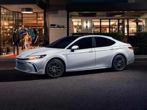 White 2025 Toyota Camry XSE parked outside a hotel