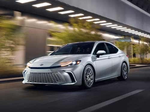 2025 Toyota Camry driving through a city
