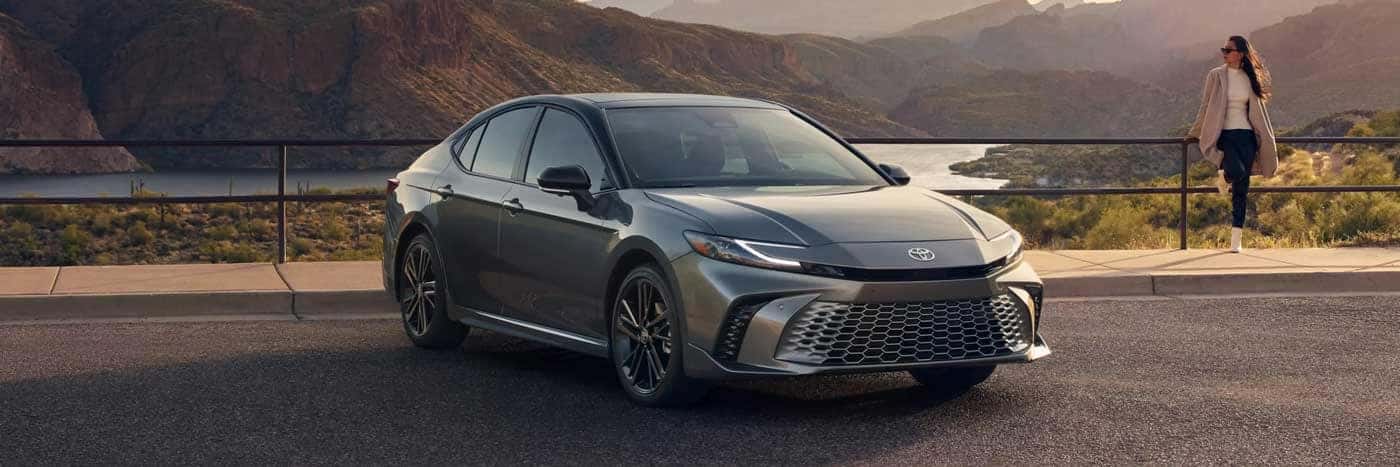 Woman standing next to a gray 2025 Toyota Camry