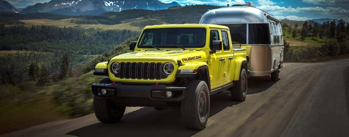 A yellow/green 2024 Jeep Gladiator Rubicon is driving to a Jeep dealer near you.