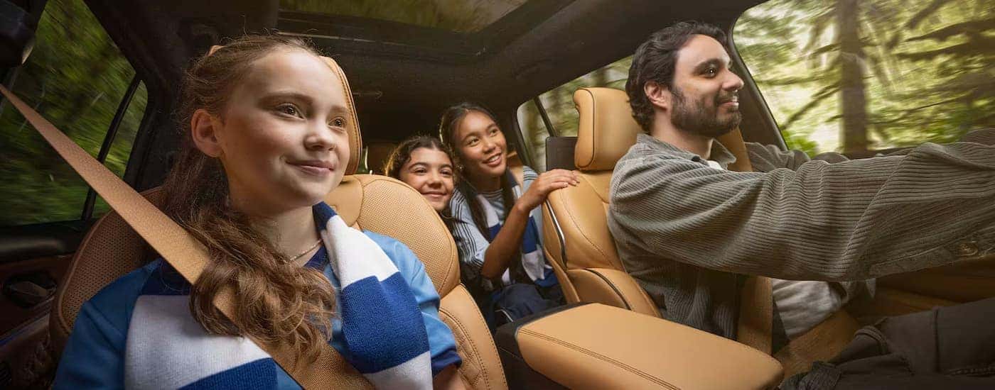 A family driving in a 2025 Jeep Grand Cherokee Summit.