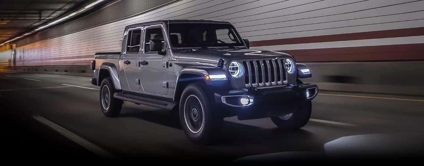 A grey 2023 Jeep Gladiator driving through a tunnel from a Jeep dealer in Delmont.