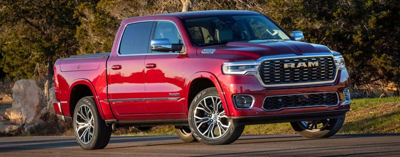 A red 2025 Ram 1500 from the front.