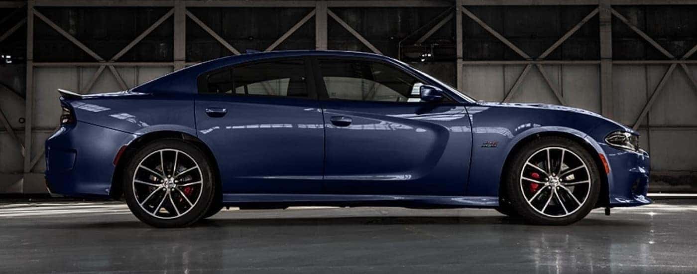 A dark blue 2017 Dodge Charger in a warehouse.