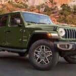 A green 2025 Jeep Wrangler Sahara Unlimited parked