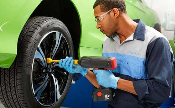 How to check your tires' health at Washington Honda of Washington | Mechanic putting tire on