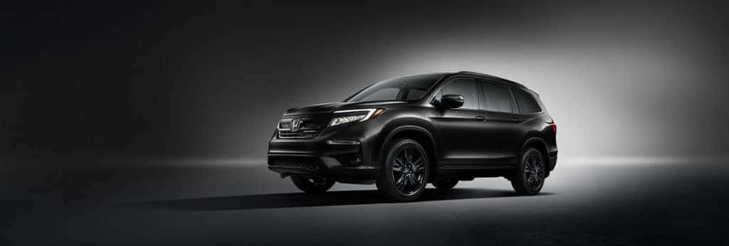 Compare the 2021 Honda Pilot vs. the 2021 Ford Explorer at Washington Honda | Pilot in dark room with lights on