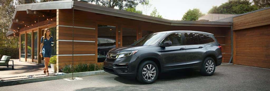 Compare the 2021 Honda Pilot vs. the 2021 Ford Explorer at Washington Honda | Pilot parked outside of home