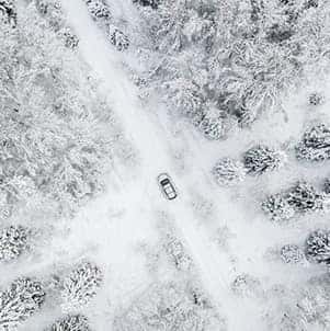 How to prepare your Honda for the winter season in Washington, PA at Washington Honda | Bird's-eye view of SUV driving thru snowy forest