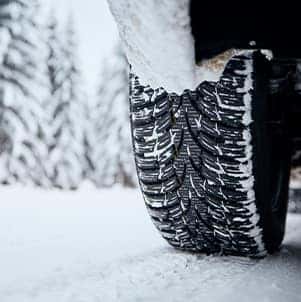 How to prepare your Honda for the winter season in Washington, PA at Washington Honda | Close-up of tire on snowy road