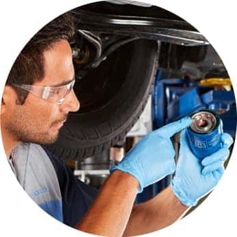 Difference between synthetic oil & conventional oil at Washington Honda | Honda Technician inspects the oil filter in his hand
