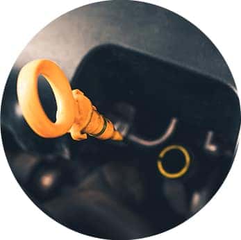 Difference between synthetic oil & conventional oil at Washington Honda | close-up of dipstick in engine