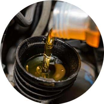 Difference between synthetic oil & conventional oil at Washington Honda | Close-up of new oil being added to engine