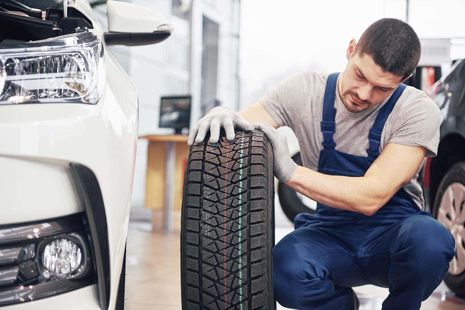 The Cold Facts of Winter Tires | Washington Honda in Washington, PA | Honda service technician inspecting brand new winter tires