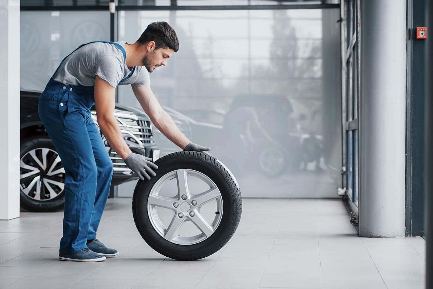 The Cold Facts of Winter Tires | Washington Honda in Washington, PA | Honda service technician getting ready to put winter tires on vehicle