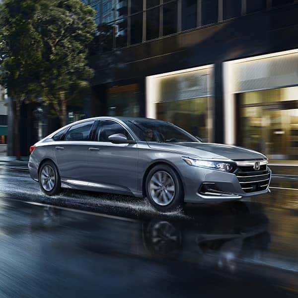 The Top 3 Most Fuel-Efficient Honda Models at Washington Honda | Silver Honda Accord Driving on Wet City Streets After Rainfall
